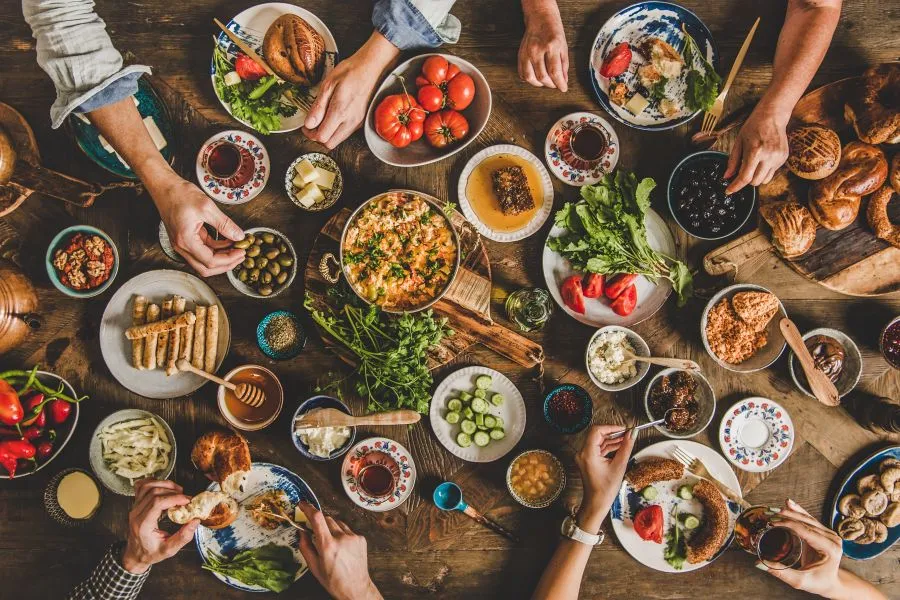 various foods on table people eating